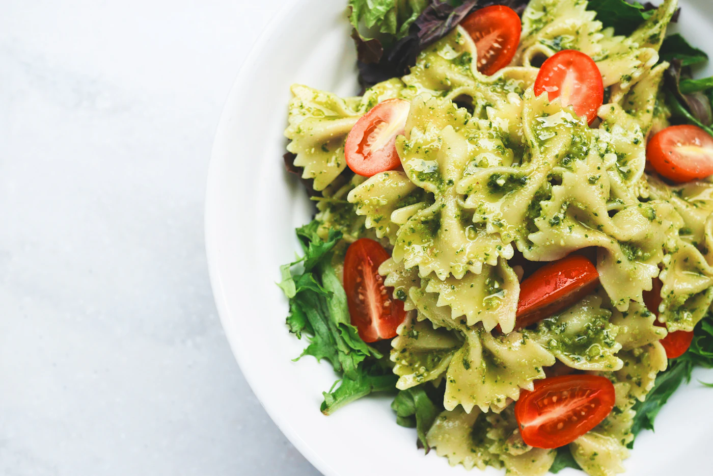 Pasta served with basil and grated cheese